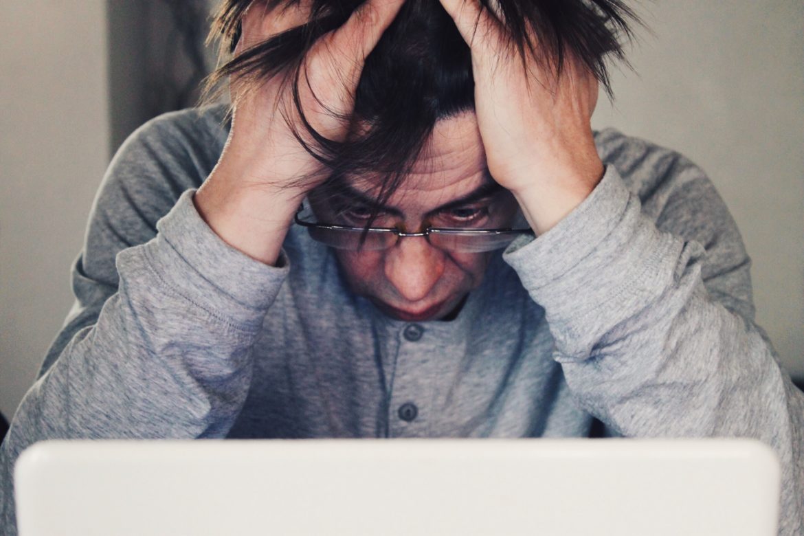 stressed guy holding head