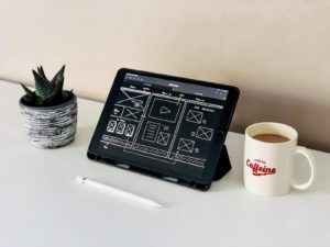 Tablet Showing Wireframe With Coffee On Side